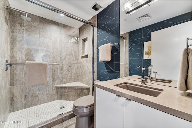 full bathroom featuring visible vents, a stall shower, toilet, and tile walls
