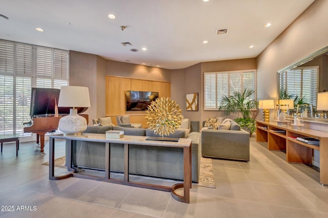 living area featuring a healthy amount of sunlight, recessed lighting, and visible vents