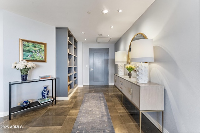 interior space with recessed lighting, baseboards, and built in shelves