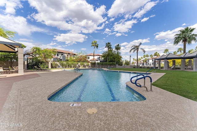 community pool with a yard, a patio, a gazebo, and fence