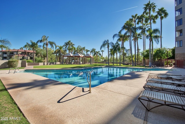 community pool featuring a gazebo and a patio area