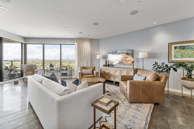 living room featuring baseboards and recessed lighting
