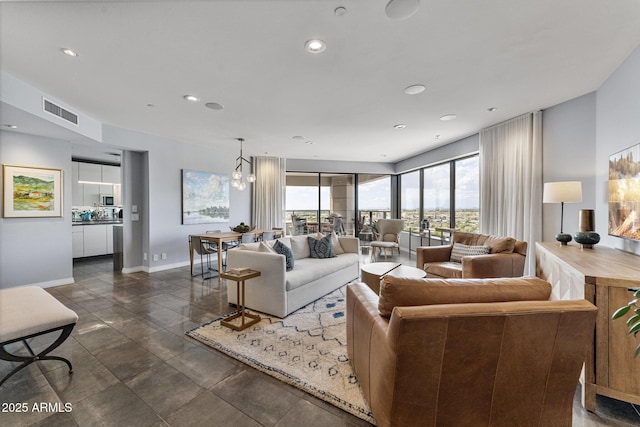 living area with visible vents, recessed lighting, and baseboards