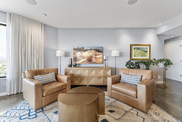 living area featuring baseboards and recessed lighting
