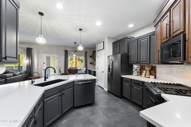 kitchen featuring sink, gray cabinetry, decorative light fixtures, stainless steel appliances, and backsplash