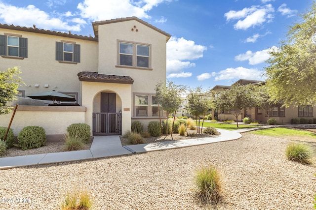 mediterranean / spanish-style home with a tile roof and stucco siding