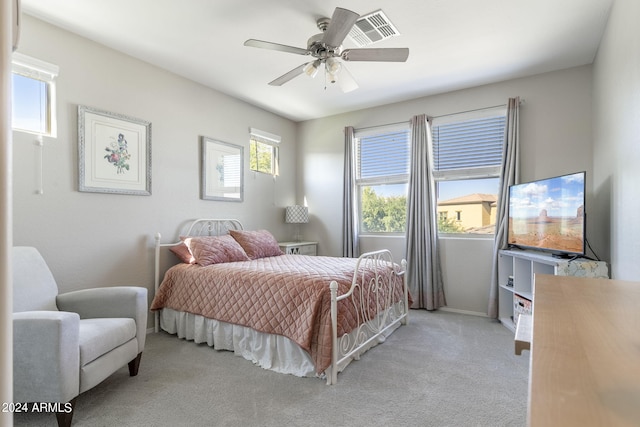 bedroom featuring a ceiling fan, light carpet, and baseboards