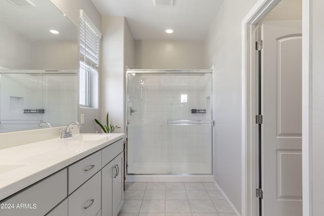 full bathroom featuring double vanity, recessed lighting, a stall shower, a sink, and tile patterned flooring