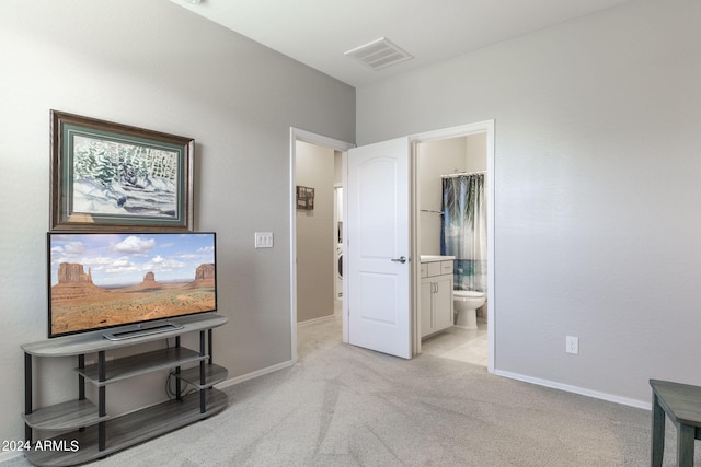 carpeted bedroom with a closet, a spacious closet, and ensuite bathroom