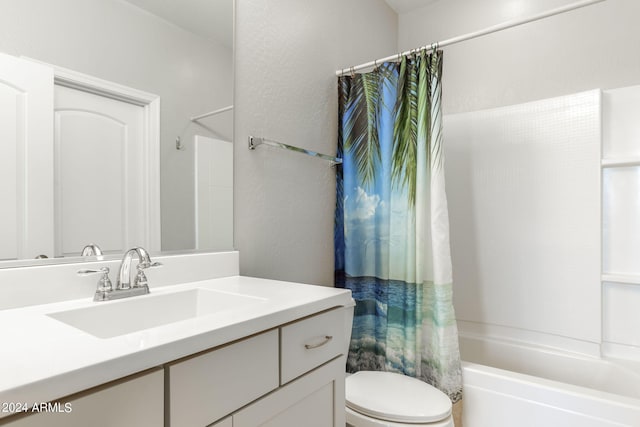 bathroom with shower / bath combo, vanity, and toilet