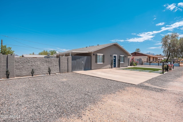 11450 E Elton Ave, Mesa, AZ 85208 - rear view of house with stucco siding, driveway, and a gate