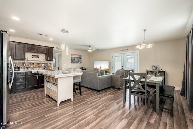 11450 E Elton Ave, Mesa, AZ 85208 - dining room featuring wood finished floors, french doors, a chandelier, ceiling fan, and recessed lighting