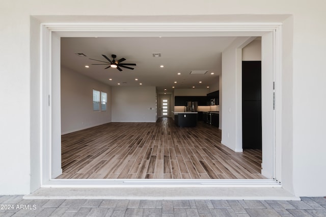 interior space with ceiling fan and light hardwood / wood-style flooring