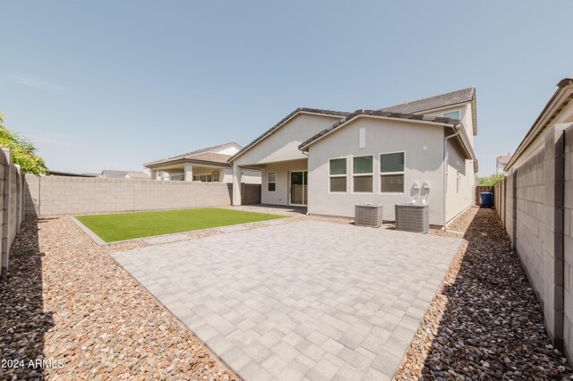 rear view of property with a patio area and central air condition unit