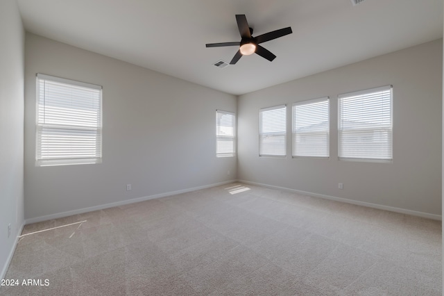 unfurnished room featuring ceiling fan, a healthy amount of sunlight, and carpet