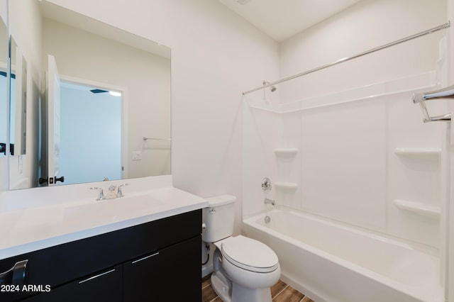 full bathroom featuring vanity,  shower combination, toilet, and hardwood / wood-style flooring