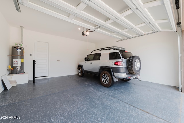 garage with water heater and a garage door opener