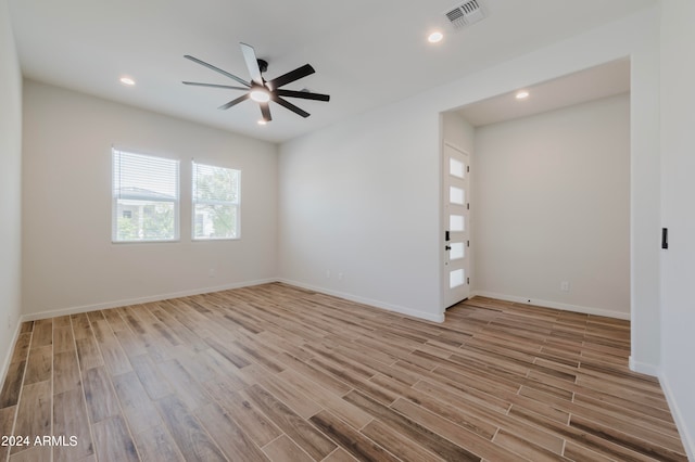 spare room with ceiling fan and hardwood / wood-style flooring