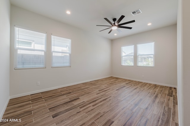 empty room with ceiling fan and hardwood / wood-style floors