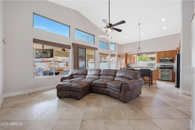 living room featuring light tile patterned floors, high vaulted ceiling, and ceiling fan