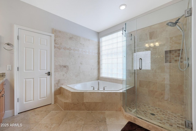 bathroom featuring tile patterned flooring, vanity, and shower with separate bathtub