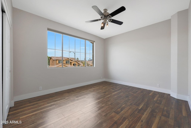 unfurnished room with ceiling fan and dark hardwood / wood-style flooring