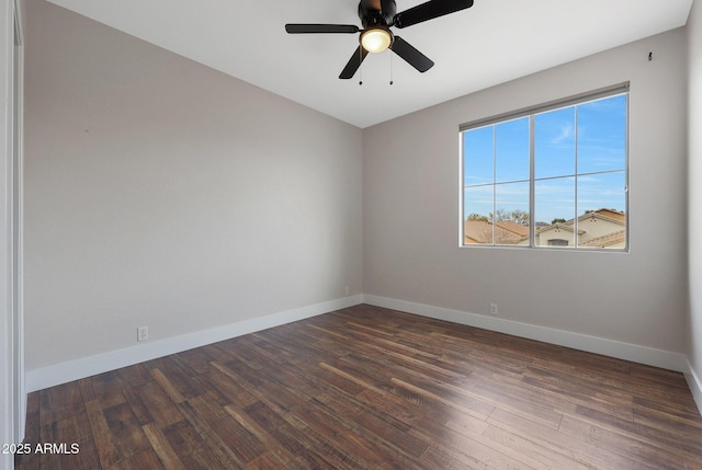 empty room with dark wood-type flooring and ceiling fan