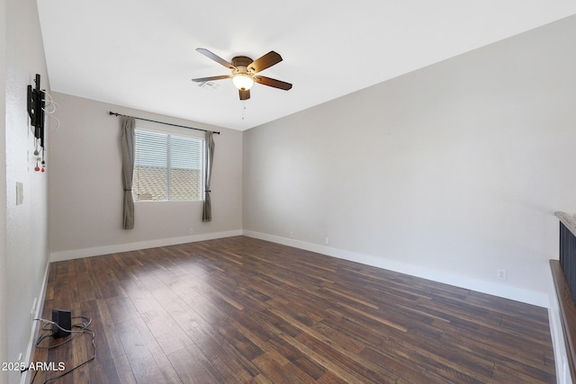 empty room with dark wood-type flooring and ceiling fan