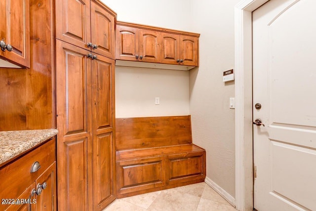 interior space featuring light stone countertops and light tile patterned floors