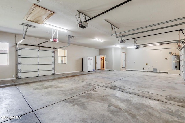 garage with electric water heater and a garage door opener