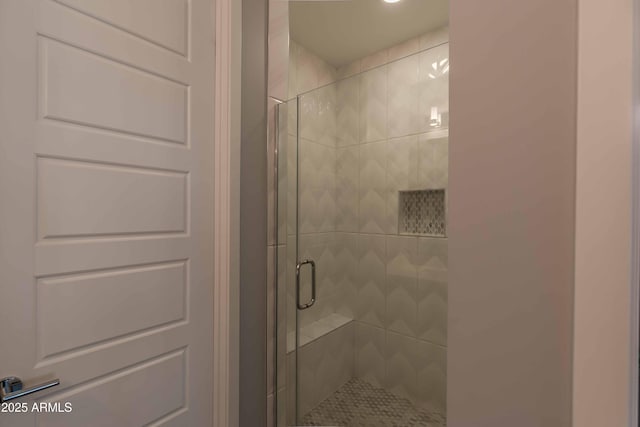 bathroom with a shower with door