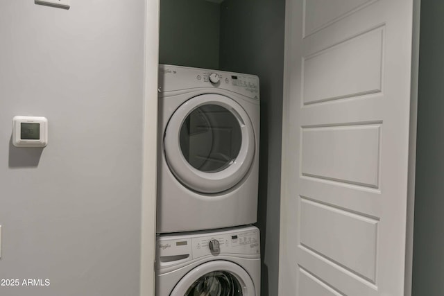 clothes washing area with stacked washer and dryer