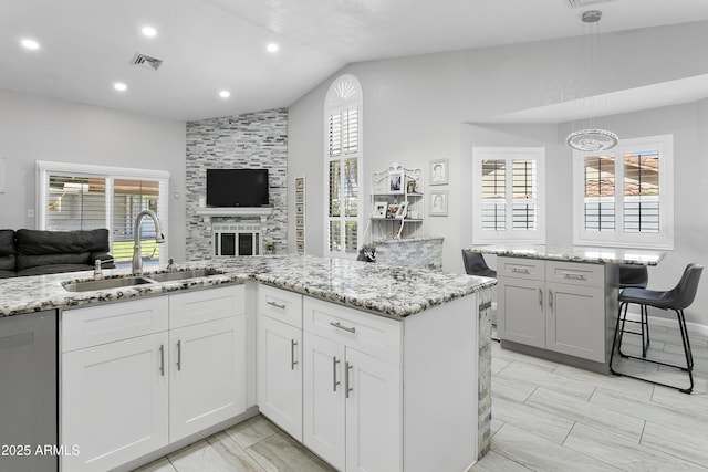 1015 E Paradise Ln, Phoenix, AZ 85022 - kitchen with open floor plan, dishwasher, vaulted ceiling, light stone countertops, and healthy amount of natural light