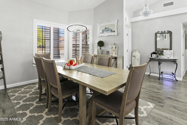 1015 E Paradise Ln, Phoenix, AZ 85022 - dining space featuring a chandelier, healthy amount of natural light, wood finished floors, and lofted ceiling