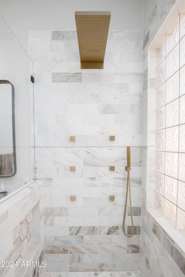 bathroom with tiled shower