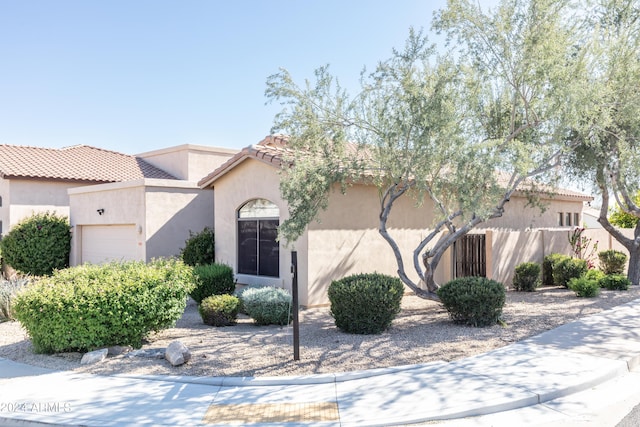 mediterranean / spanish-style house with a garage