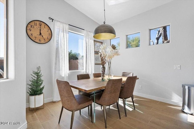 dining space with lofted ceiling and wood-type flooring