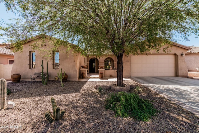 view of front facade with driveway, an attached garage, a tiled roof, and stucco siding