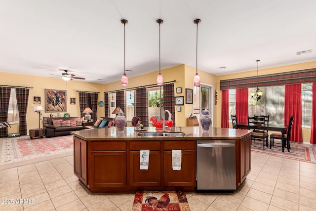 kitchen with light tile patterned floors, a center island with sink, visible vents, a sink, and stainless steel dishwasher