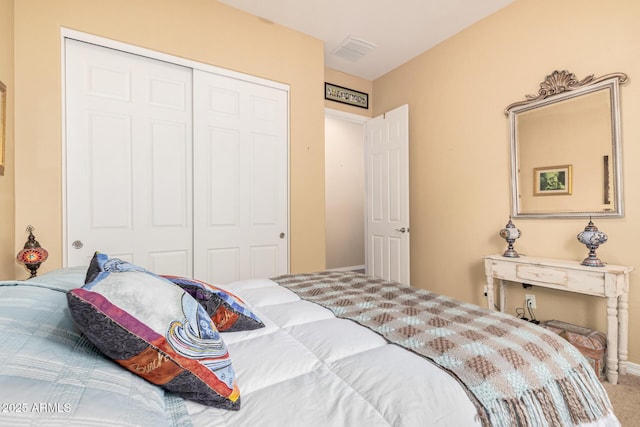 carpeted bedroom featuring a closet and visible vents