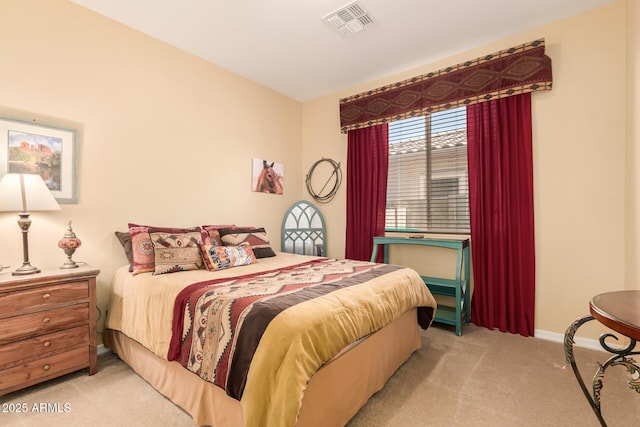 bedroom featuring baseboards, visible vents, and light colored carpet