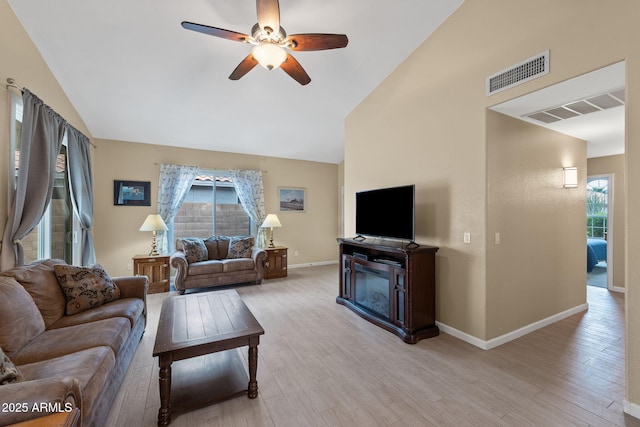 1770 W Derringer Way, Chandler, AZ 85286 - living room featuring visible vents, a ceiling fan, a glass covered fireplace, and a wealth of natural light