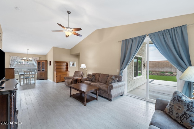 1770 W Derringer Way, Chandler, AZ 85286 - living area with baseboards, vaulted ceiling, ceiling fan with notable chandelier, and light wood-type flooring