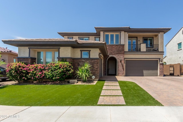 3408 E Daley Ln, Phoenix, AZ 85050 - prairie-style house featuring a balcony, decorative driveway, stucco siding, a garage, and a front yard