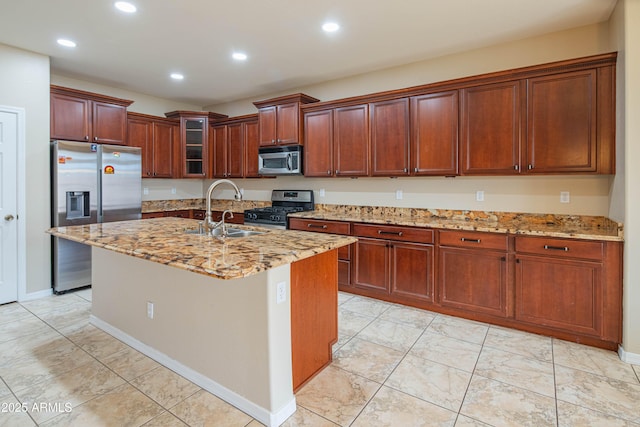 kitchen with a sink, stainless steel appliances, light stone counters, and recessed lighting