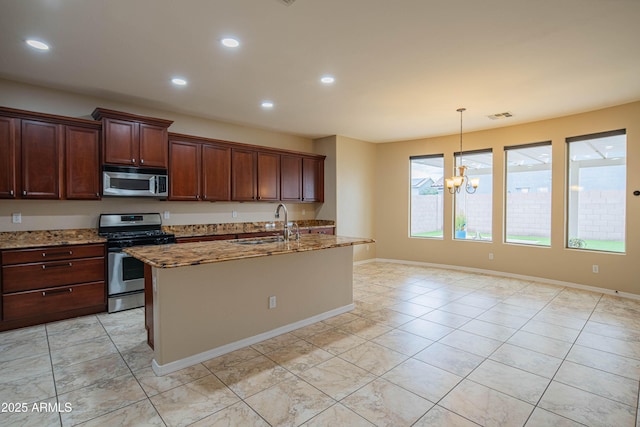 kitchen with light stone countertops, visible vents, an inviting chandelier, a sink, and appliances with stainless steel finishes