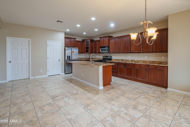 kitchen with a notable chandelier, an island with sink, light stone counters, recessed lighting, and stainless steel appliances