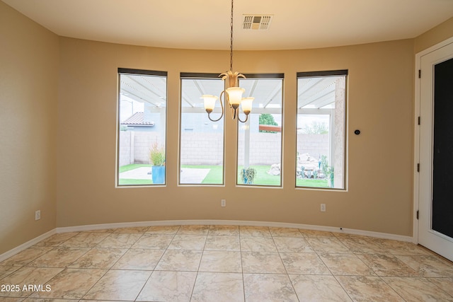 unfurnished dining area featuring visible vents, baseboards, and an inviting chandelier