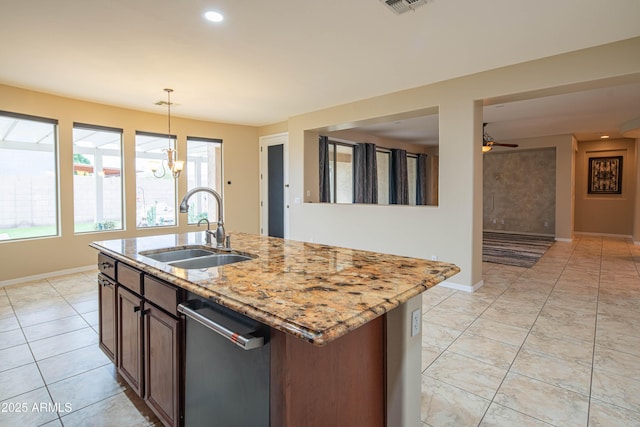 kitchen featuring baseboards, dishwasher, light stone counters, ceiling fan with notable chandelier, and a sink