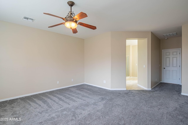 empty room featuring baseboards, visible vents, a ceiling fan, and carpet